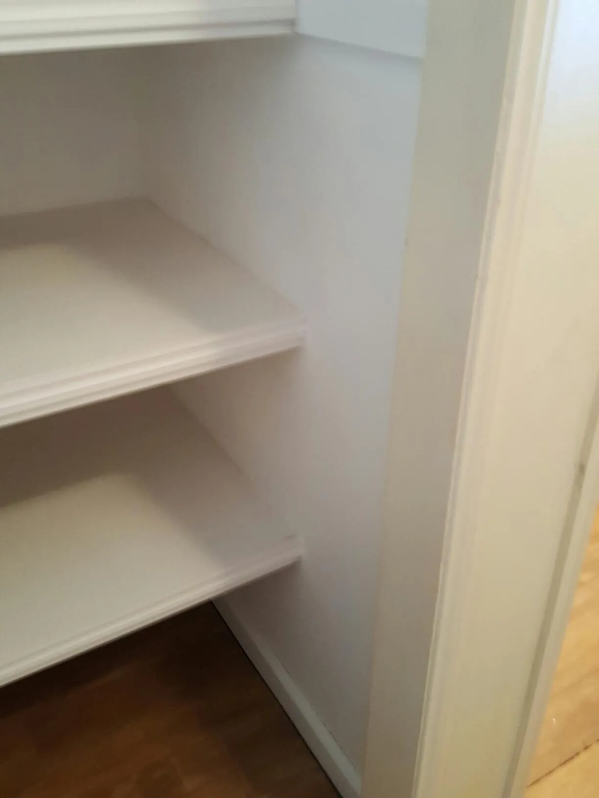 The new shelves in the linen cupboard, seen from the doorway.