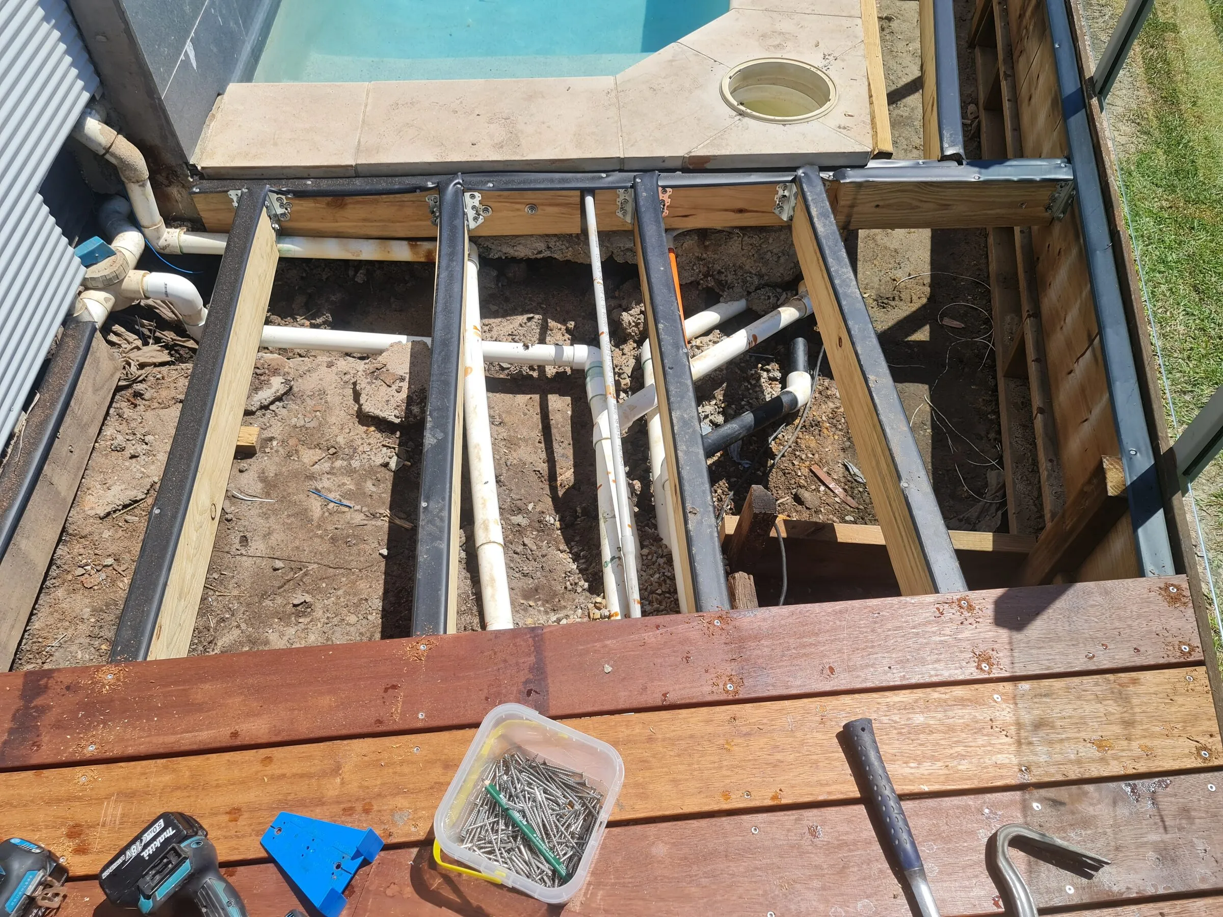 New joists and steel supports in over the pipework, with the first run of hardwood boards laid.
