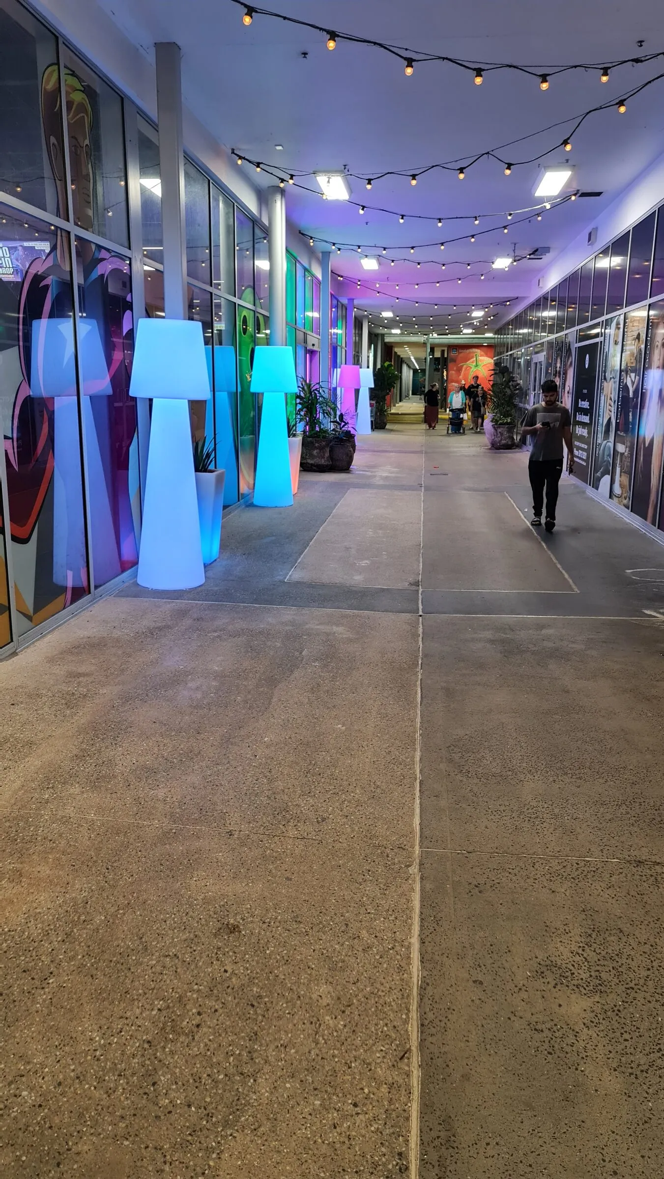 The finished run of lamps and planters down the length of the centre walkway after dark.