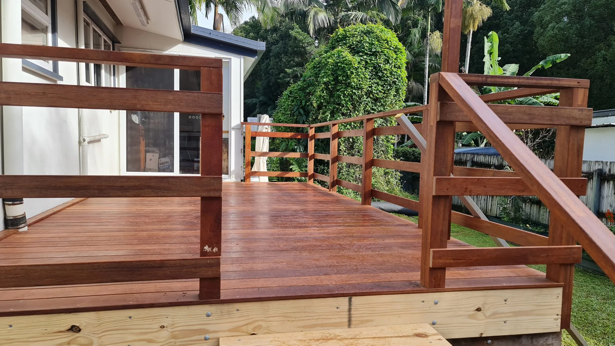 The finished boards and balustrade seen from the corner, stairs off to the right.